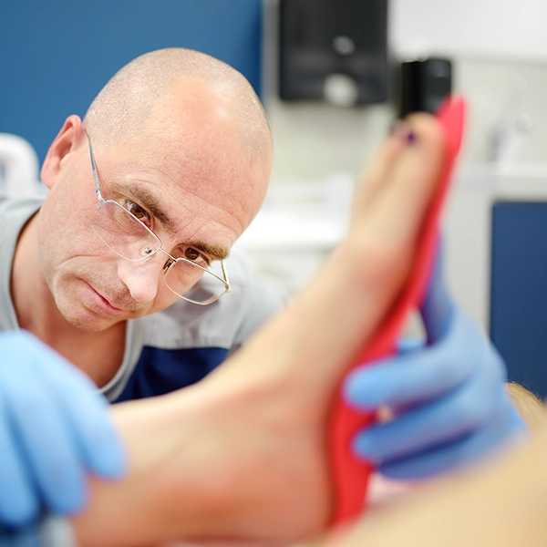 Doctor fitting orthotics